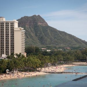 a large body of water with a mountain in the background