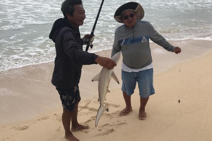 a person standing next to a body of water