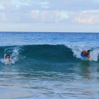 a man riding a wave on a surfboard in the ocean