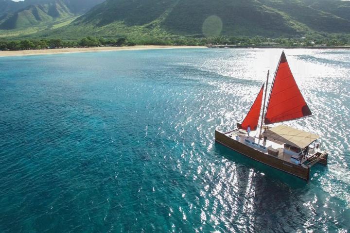 a small boat in a body of water with a mountain in the background
