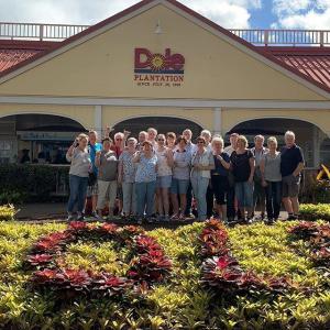 a group of people standing in a garden