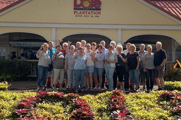 a group of people standing in a garden