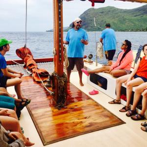 a group of people sitting at a dock