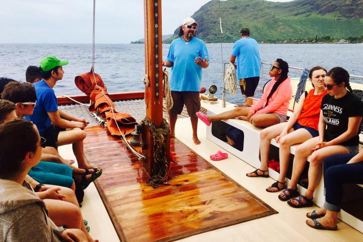a group of people sitting at a dock
