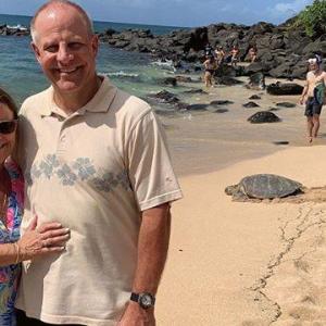 a man standing on a beach posing for the camera