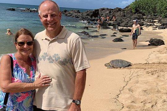 a man standing on a beach posing for the camera