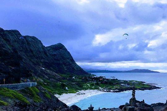 a large body of water with a mountain in the background
