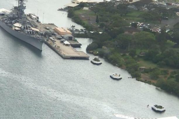 a large body of water with a city in the background