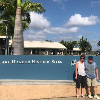 a person standing in front of palm trees on a beach