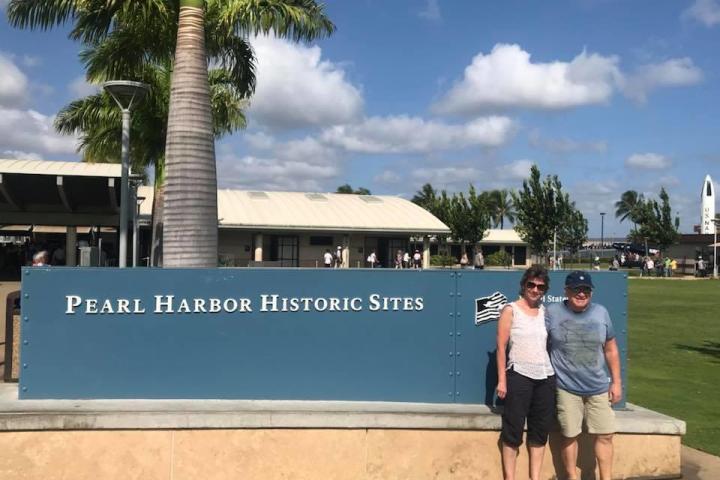 a person standing in front of palm trees on a beach