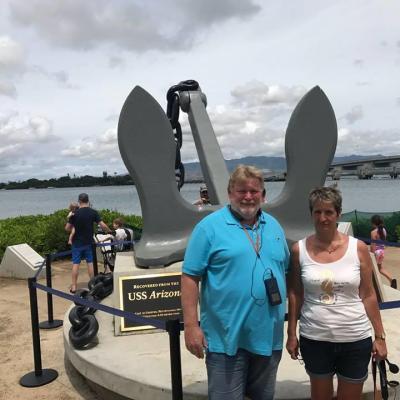 a group of people standing in front of a body of water