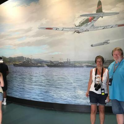 a group of people standing next to a body of water