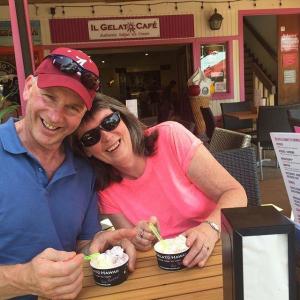 a man and a woman sitting at a table with food