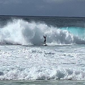 a man riding a wave on a surfboard in the ocean