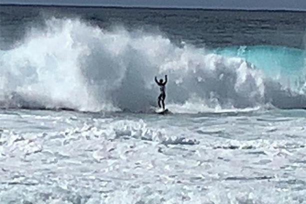 a man riding a wave on a surfboard in the ocean
