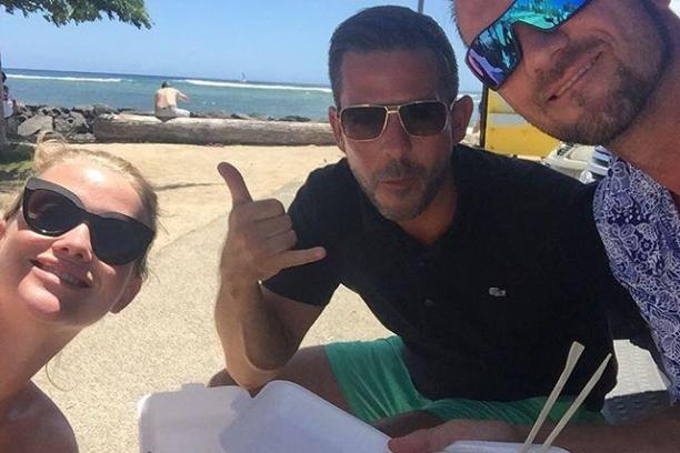 a group of people sitting at a beach