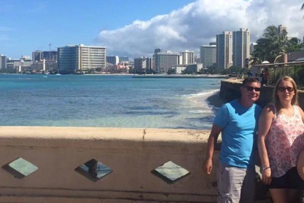 a group of people standing in front of a beach