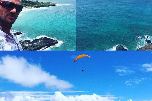a man standing next to a body of water next to the ocean