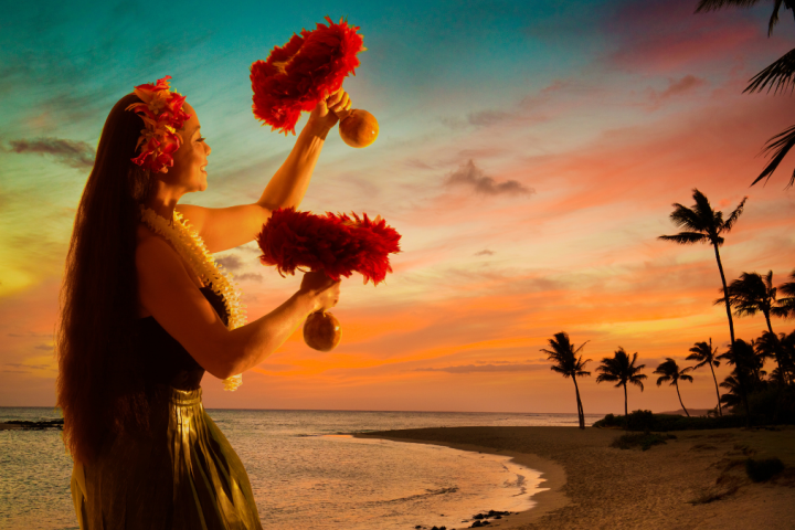 a person standing in front of a sunset over a body of water